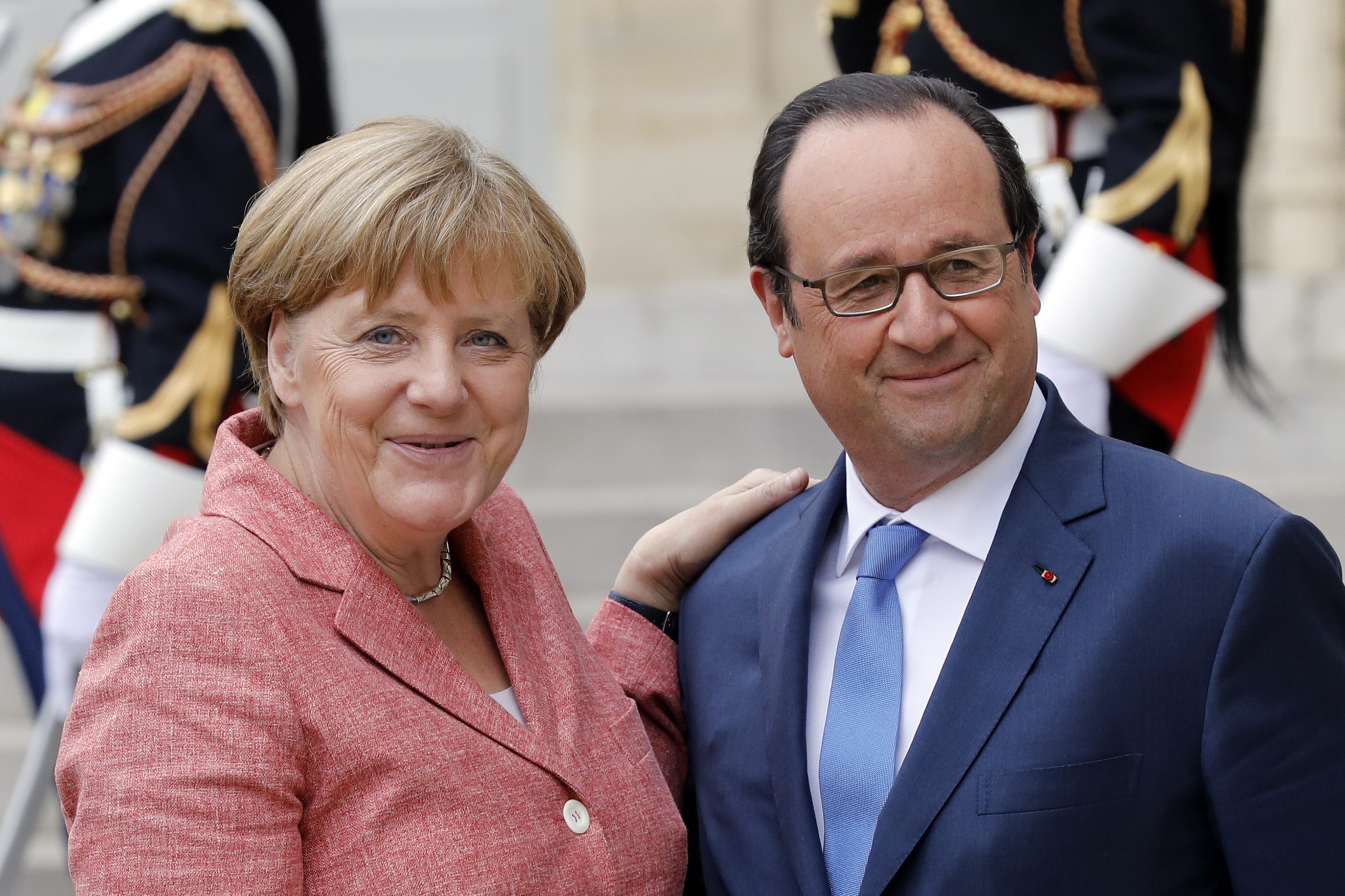 German Chancellor Angela Merkel and French President Francois Hollande smiling at the Western Balkans summit at the Elysee Palace.