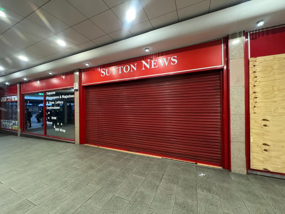 The former Sutton News sits near the bus stops and is one of the first units you come to but is now boarded up and has attracted vandals with one of its windows smashed