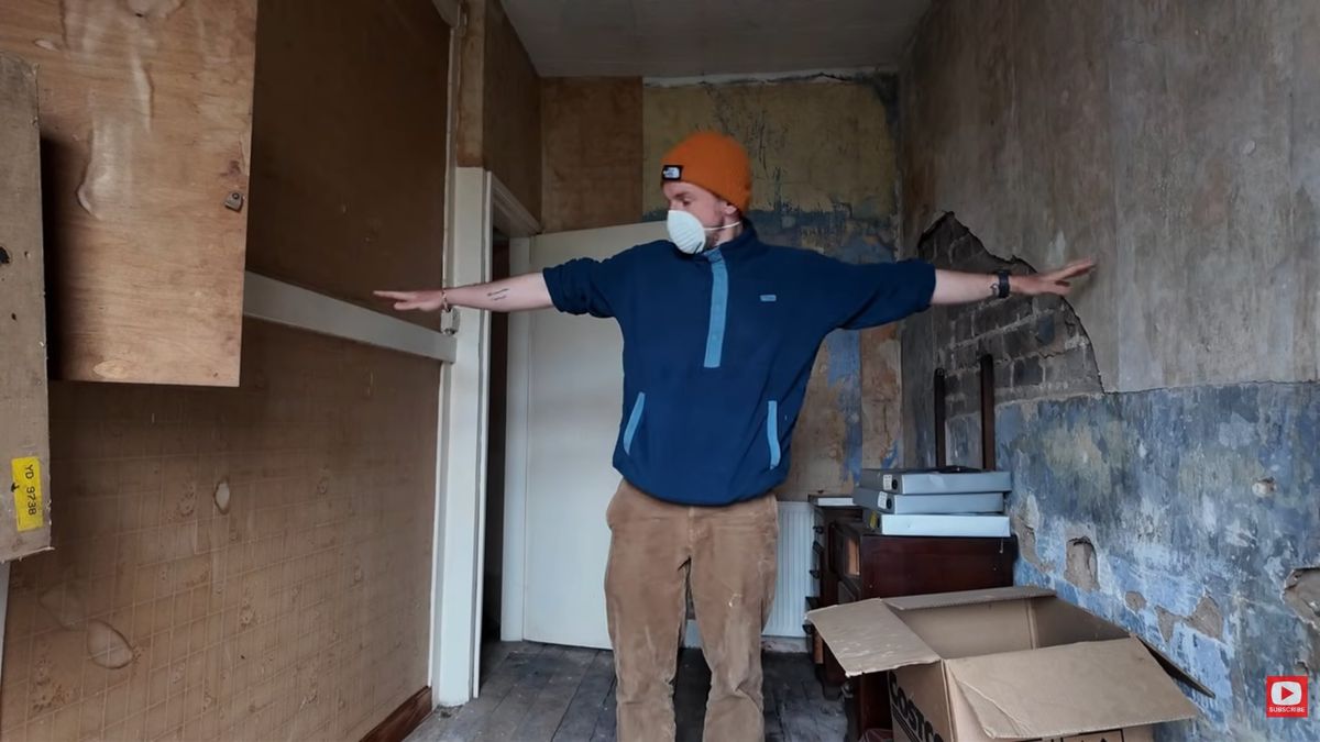 A man wearing a facemask stretching his arms out