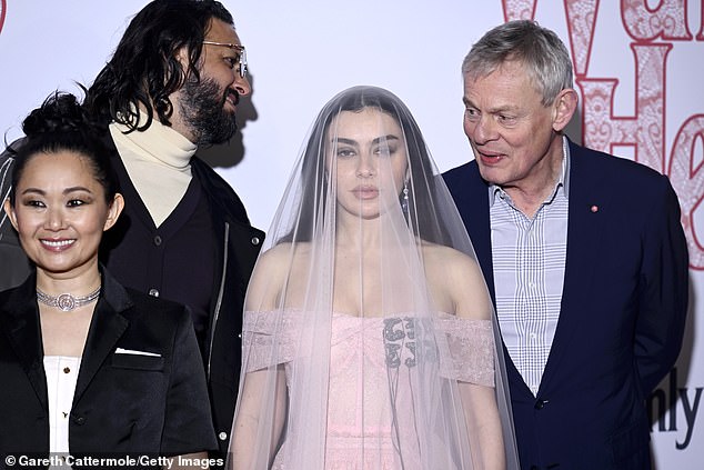 While gathered with the cast on the red carpet in London, Martin couldn't hide his beaming smile as he posed for snaps next to Charli XCX, who has penned the soundtrack for the film