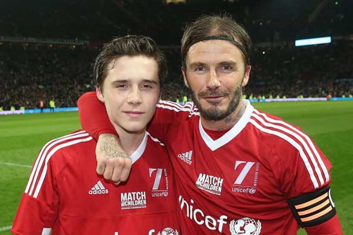 David Beckham of Great Britain and Ireland poses with his son Brooklyn Beckham after the David Beckham Match for Children in aid of UNICEF