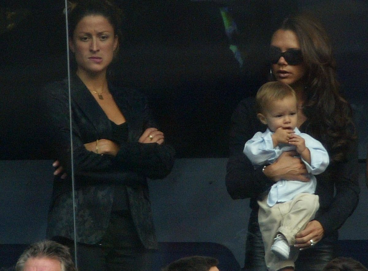 Rebecca Loos seen behind Victoria and Romeo Beckham in 2003