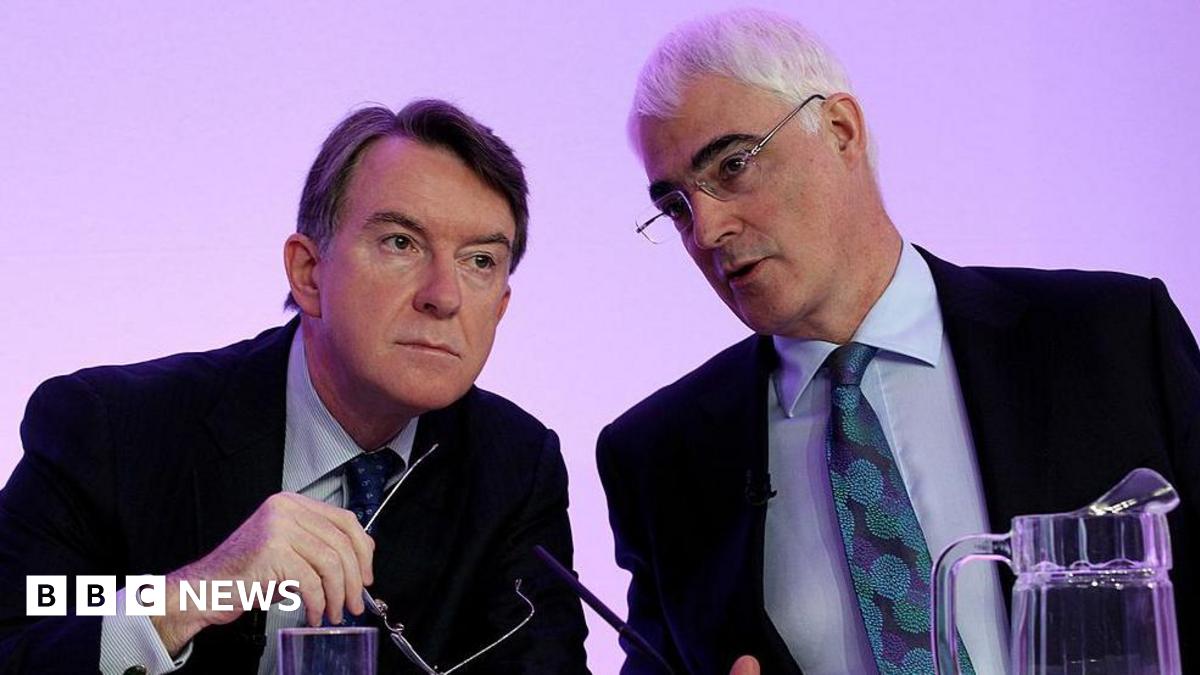 Former Business Secretary Peter Mandelson, wearing a dark suit jacket, light shirt and dark patterned tie sits on the left of former chancellor Alistair Darling, wearing a dark suit jacket, light blue shirt and turquoise and dark blue tie