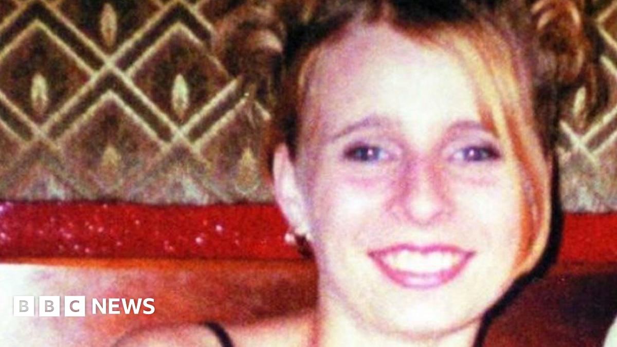 Victoria Hall smiles at the camera. She has blonde hair that is cut in a bob style. She wears a light blue top which matches blue eyeshadow she is wearing.