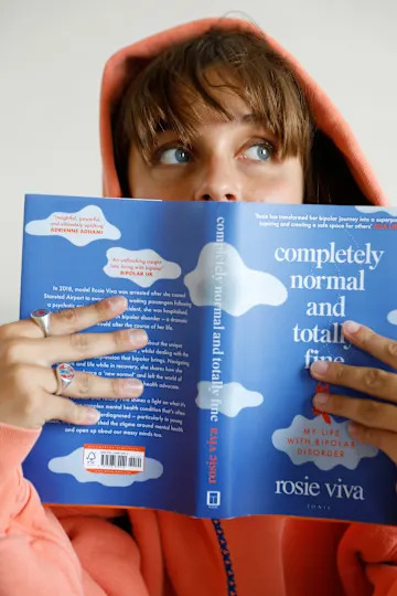 Rosie van Amerongen posing with her book 