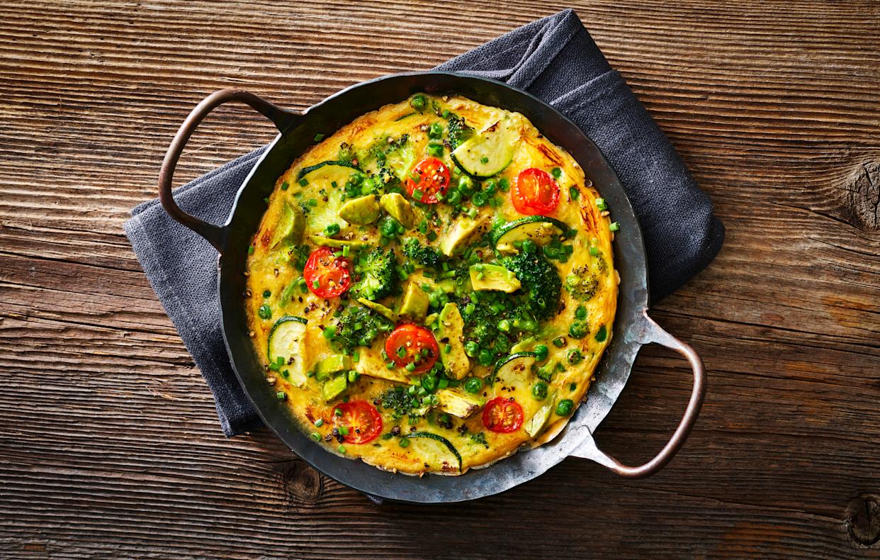 Overhead shot of a pea, tomato, avocado and courgette omelette 