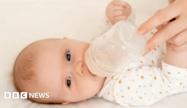 A baby with a bottle