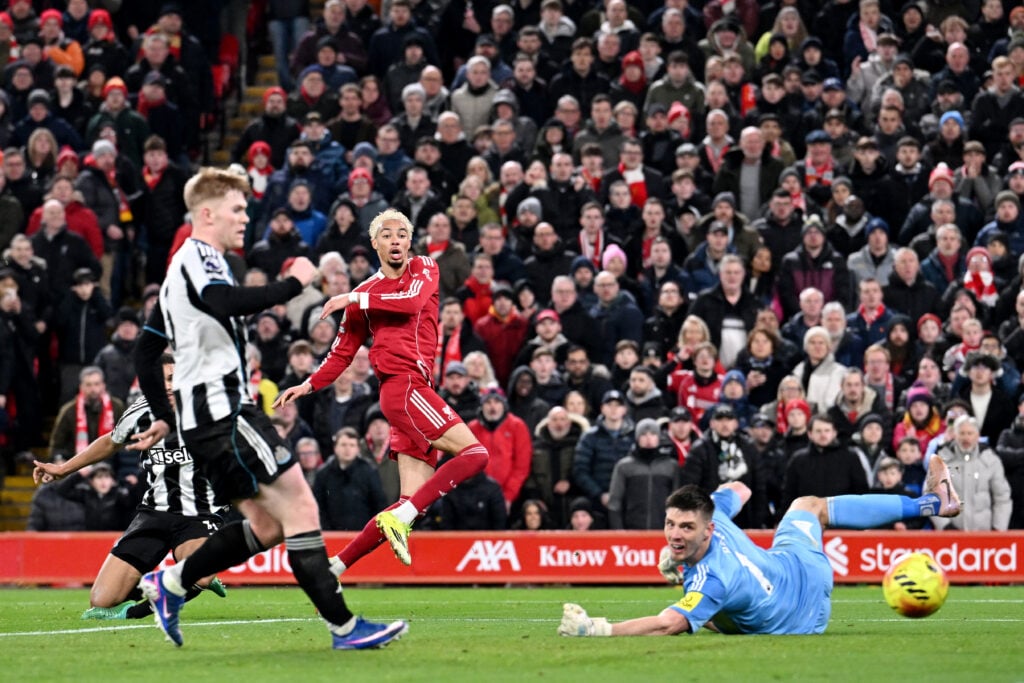 Hugo Ekitike scores past Nick Pope during Liverpool's Premier League match against Newcastle United at Anfield.