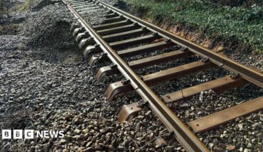 A rail track with ballast washed away underneath it
