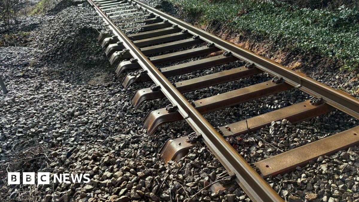 A rail track with ballast washed away underneath it