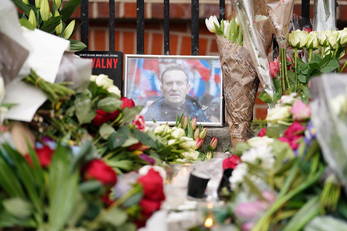 Tributes to the slain Russian opposition leader Alexei Navalny were left outside the Russian embassy in London after his death (PA Archive)
