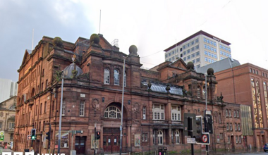 A large red brick theatre, sitting on a street corner