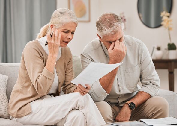 Married, couple and together with documents in frustration for finances, vacation or retirement at home. Elderly, man and woman on sofa with paperwork