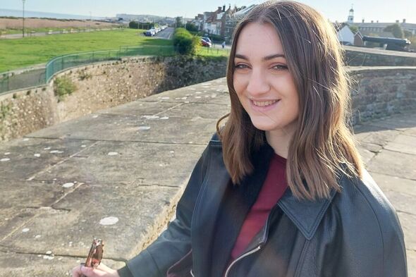 woman looking at the sea in black leather jacket