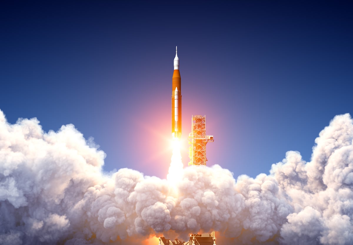 A rocket shoots into the sky.