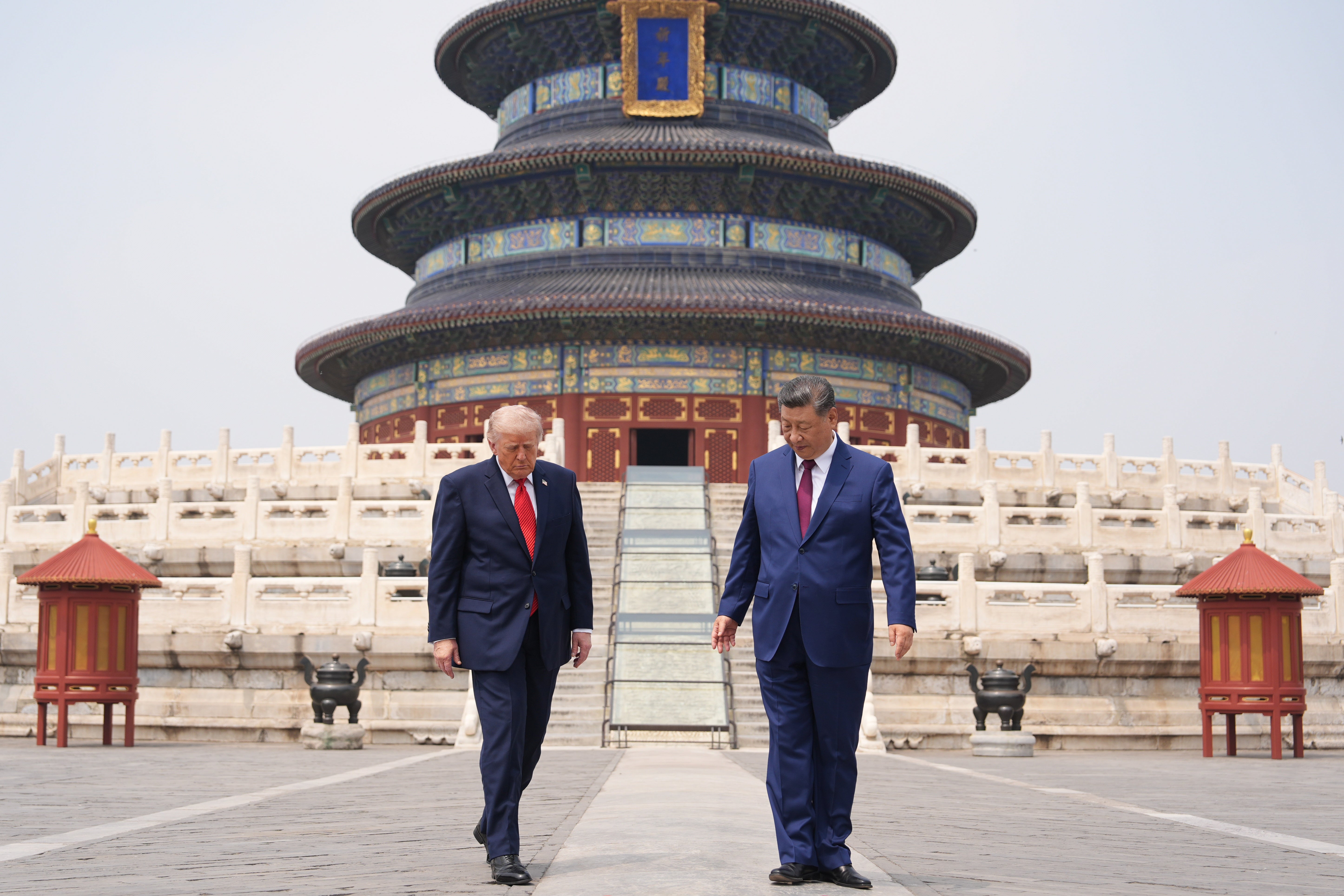 Donald Trump, left, walks with Chinese President Xi Jinping at the Temple of Heaven on Thursday May 14