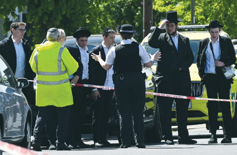 :ocal residents look on from outside a cordoned-off area in the Golders Green neighborhood of north London last month, following the stabbing of two people nearby.