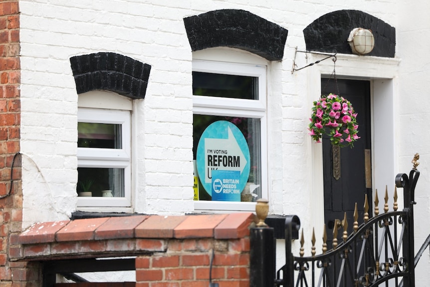 A sign supporting Reform UK in a window of a home.