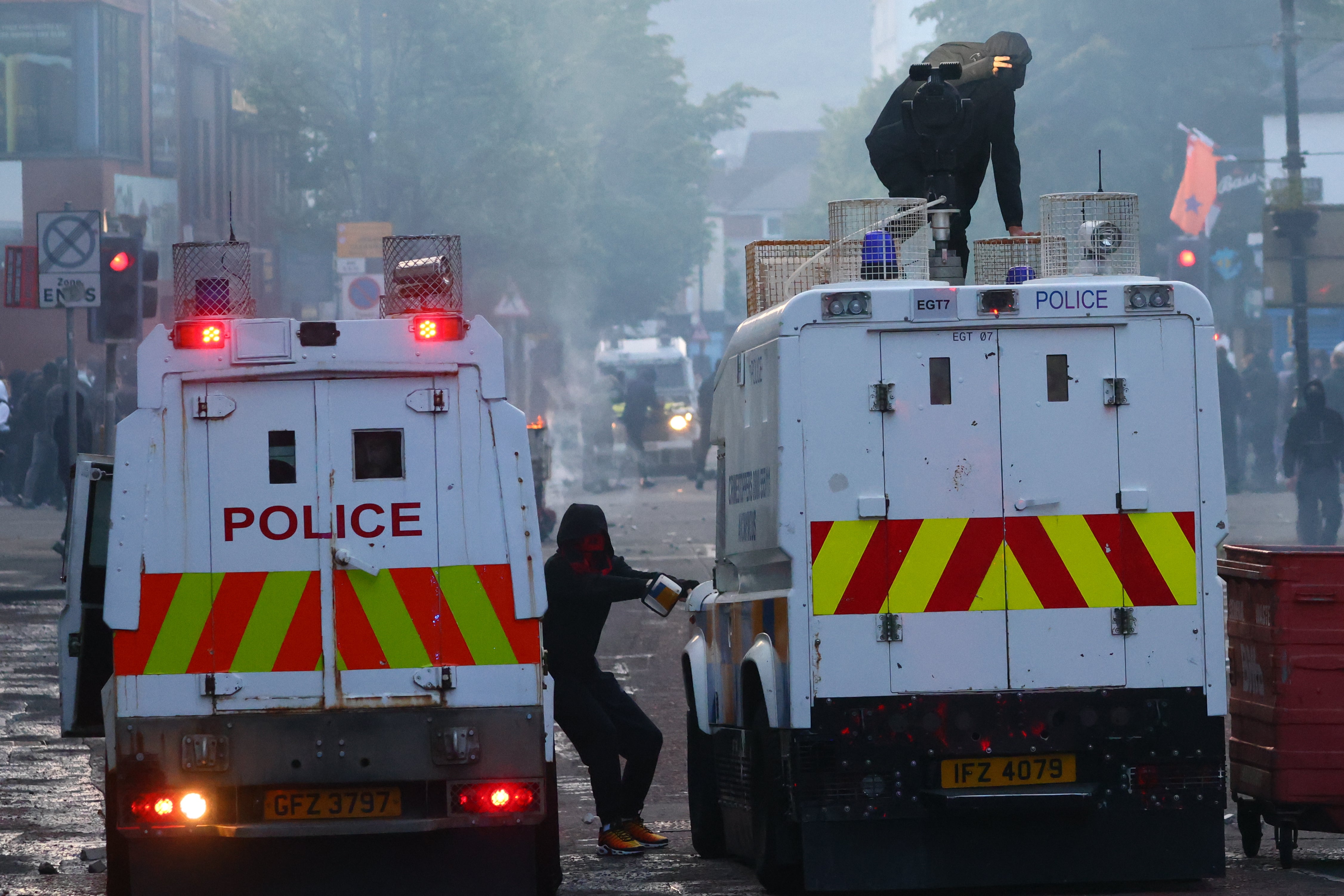 Police vehicles come under attack from protesters late on Tuesday