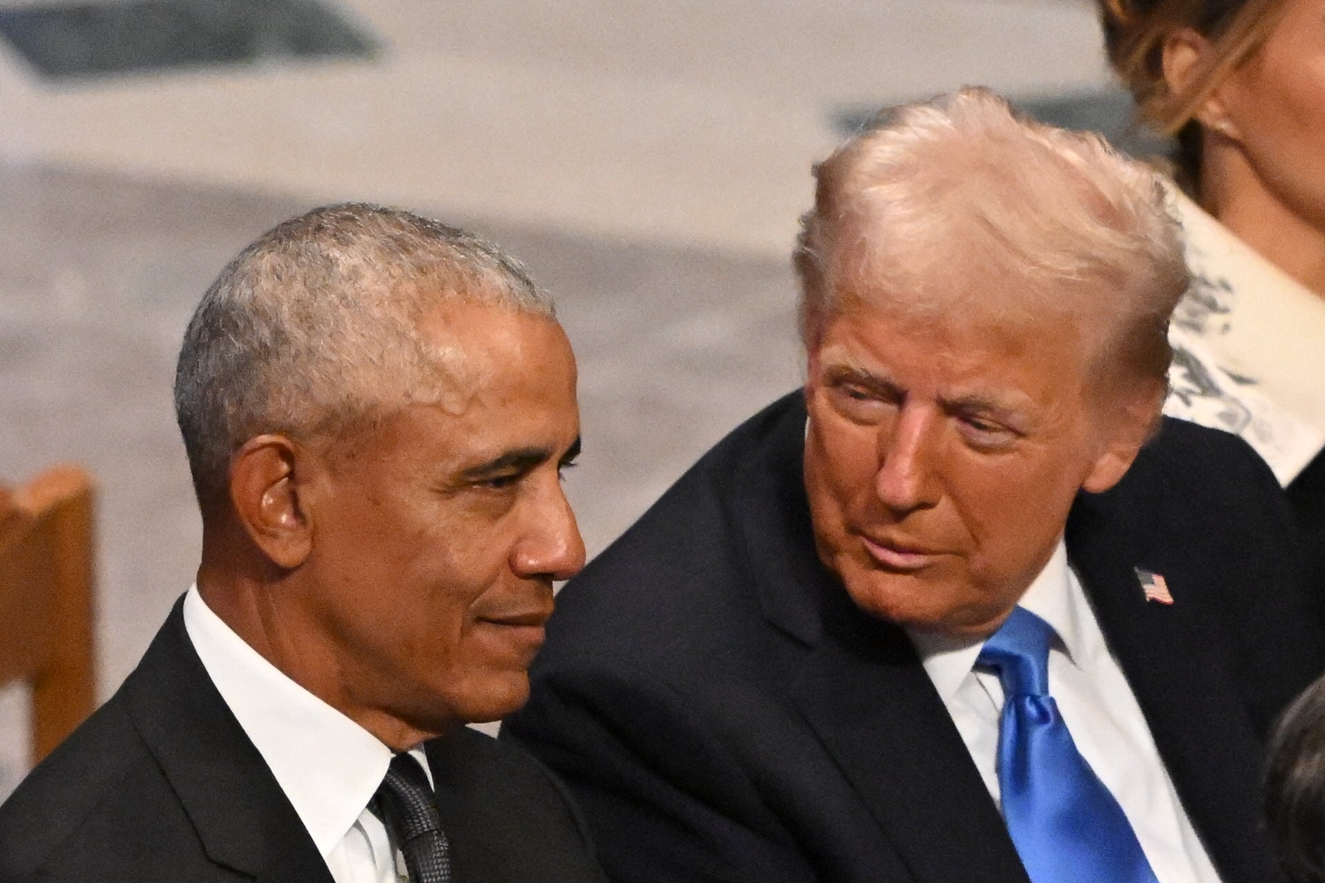 Trump speaks with former President Barack Obama as they attend the State Funeral Service for former President Jimmy Carter on January 9, 2025