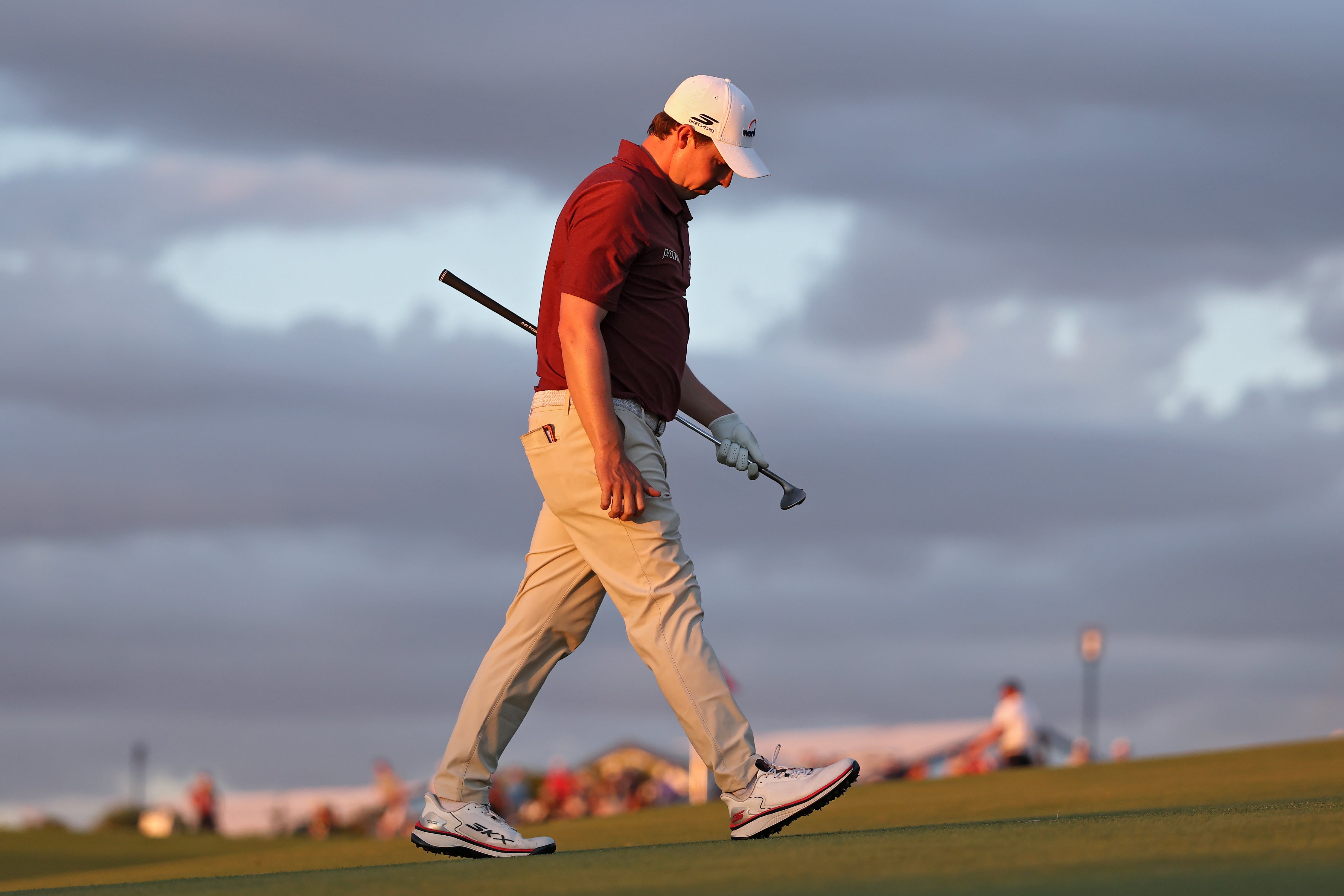 Matthew Fitzpatrick of England walks the 18th green after a disappointing day
