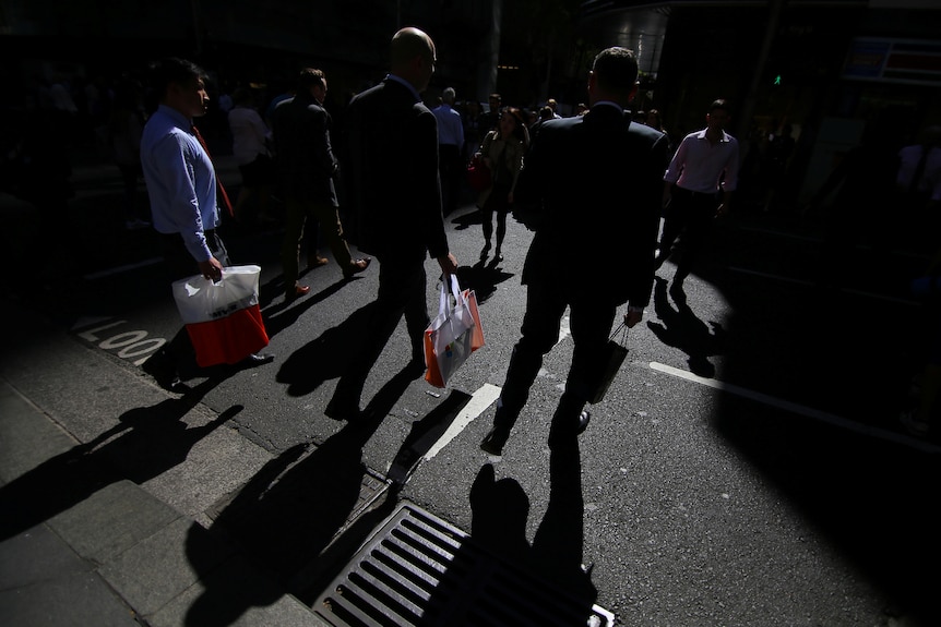 Workers cross a Sydney street