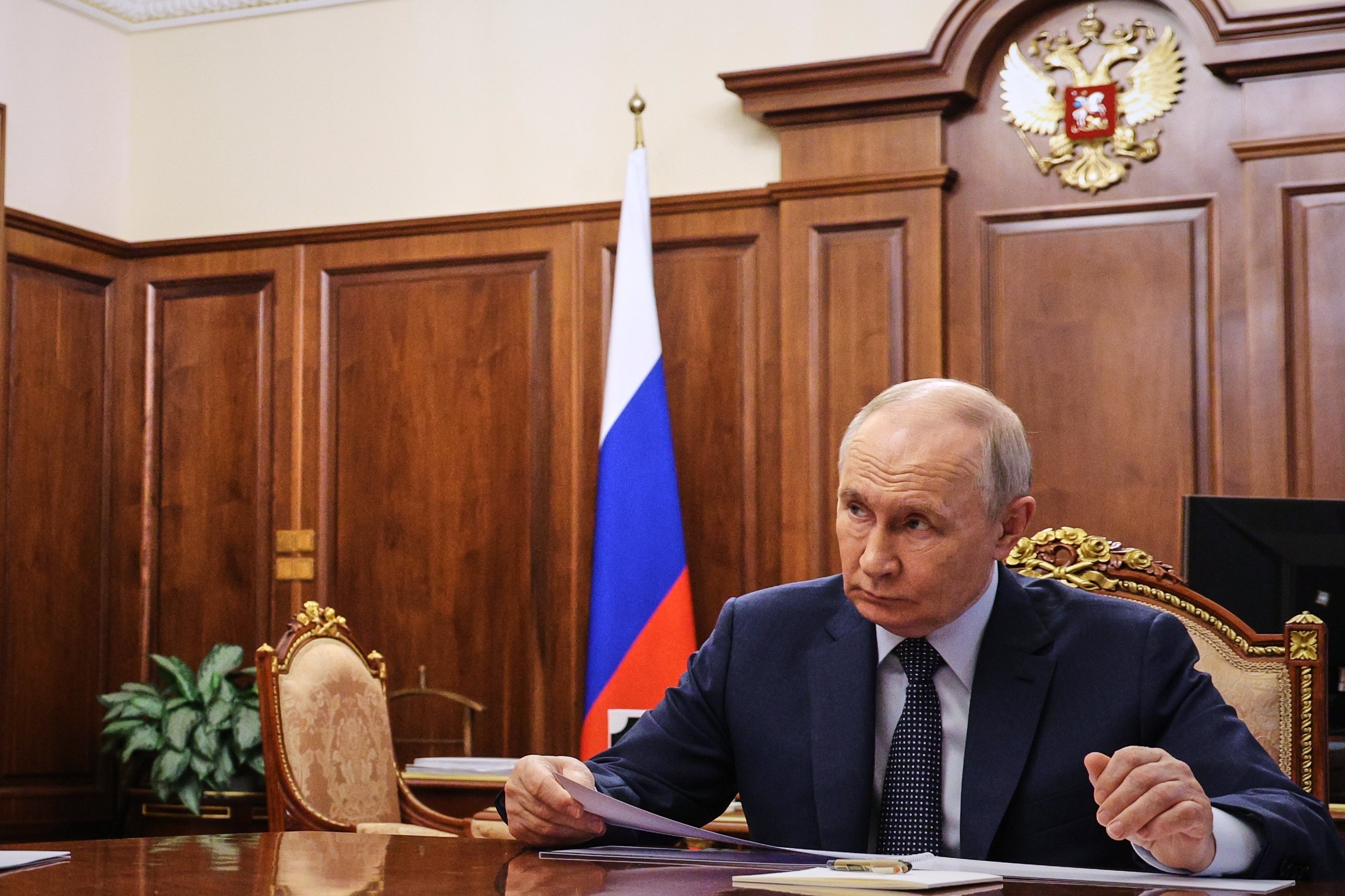 Russian president Vladimir Putin listens to President of the Russian Chamber of Commerce and Industry Sergei Katyrin at the Kremlin in Moscow