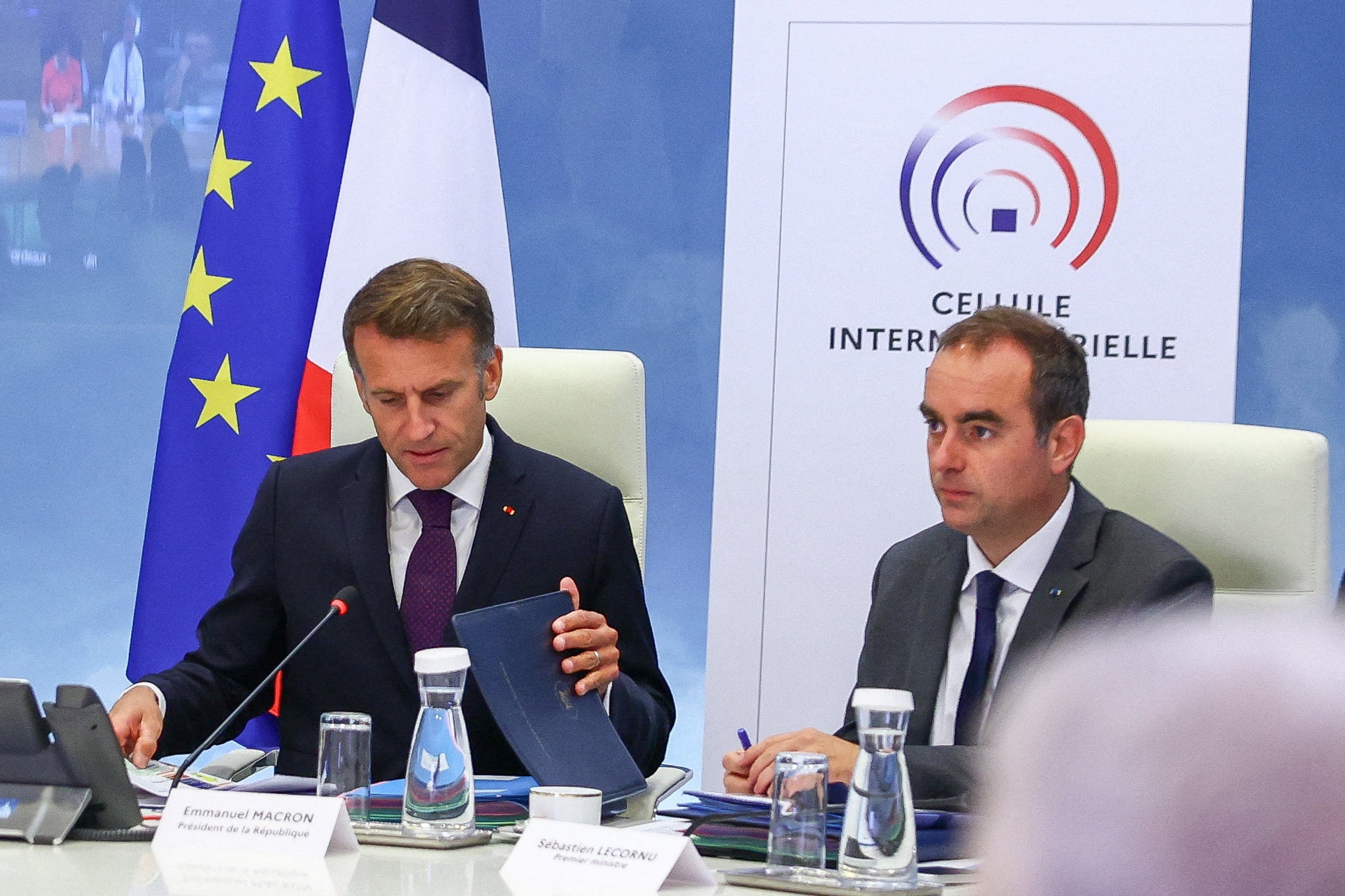 France's President Emmanuel Macron (L) and France's Prime Minister Sebastien Lecornu (R) attend a meeting with members of the cabinet to discuss wildfires in the country, at the Hotel de Beauvau, the French Interior Ministry, in Paris on July 27, 2026.