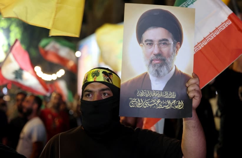 A supporter of Iran-backed terrorist group Hezbollah, holds a portrait of Iran's supreme leader Mojtaba Khamenei during an anti-US and anti-Israel protest in Beirut's southern suburbs on June 10, 2026.