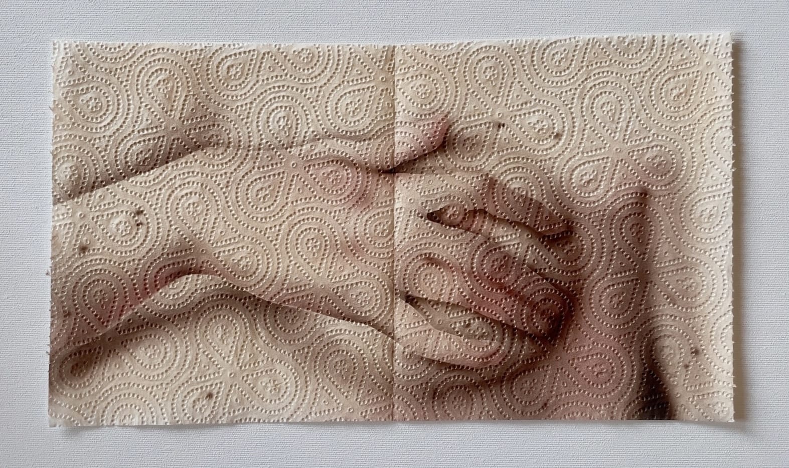 a painting of a hand and breast from a Renaissance painting on two sheets of paper towel