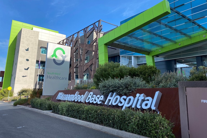 A colourful modern looking hospital with sign reading Warrnambool Base Hospital