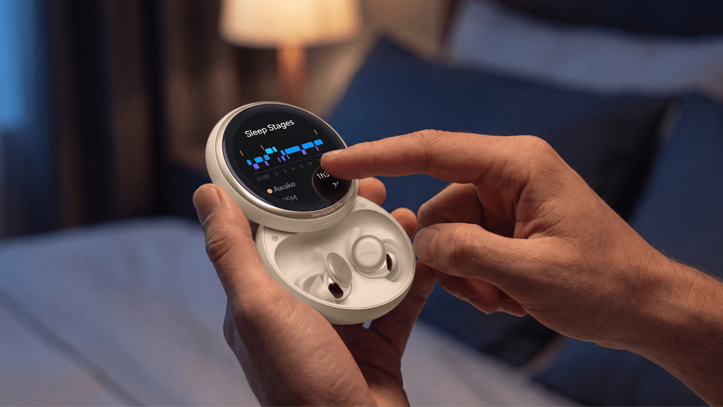 A person taps the OLED touchscreen included on the charging case of Anker’s new sleepbuds.