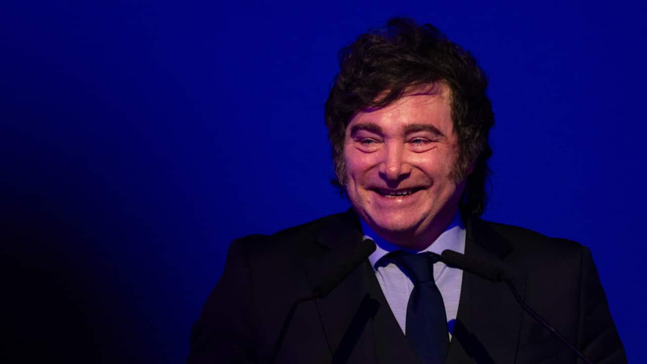 A middle-aged white man wearing a dark suit, smiling.