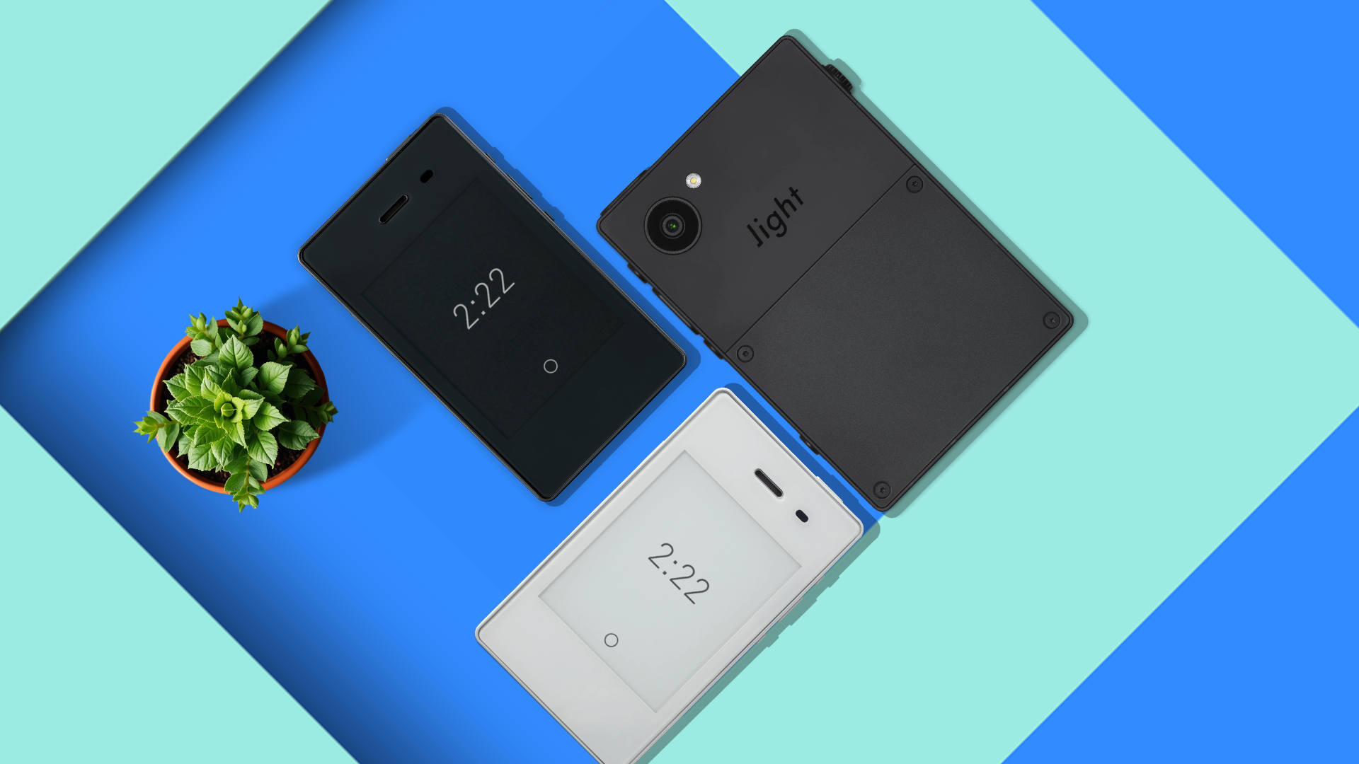 A minimalist scene with some minimalist phones and a flower vase.