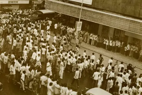 Sippy Films A sepia-toned image of a queue outside Mumbai's Minerva theatre where Sholay ran for more than five years. 