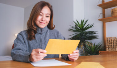 A stock image of woman reading card.