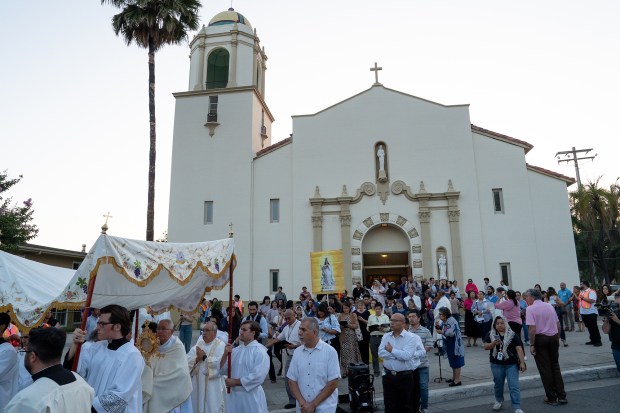 Attendees exit Sacred Heart Church in Altadena at the conclusion...