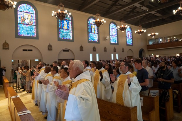 Attendees fill Sacred Heart Church in Altadena during a Mass...