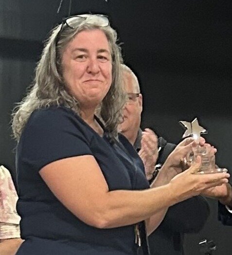 St. Johns Classical Academy teacher Sylvia Mencner shows off her Charter School Champion of the Year Award.