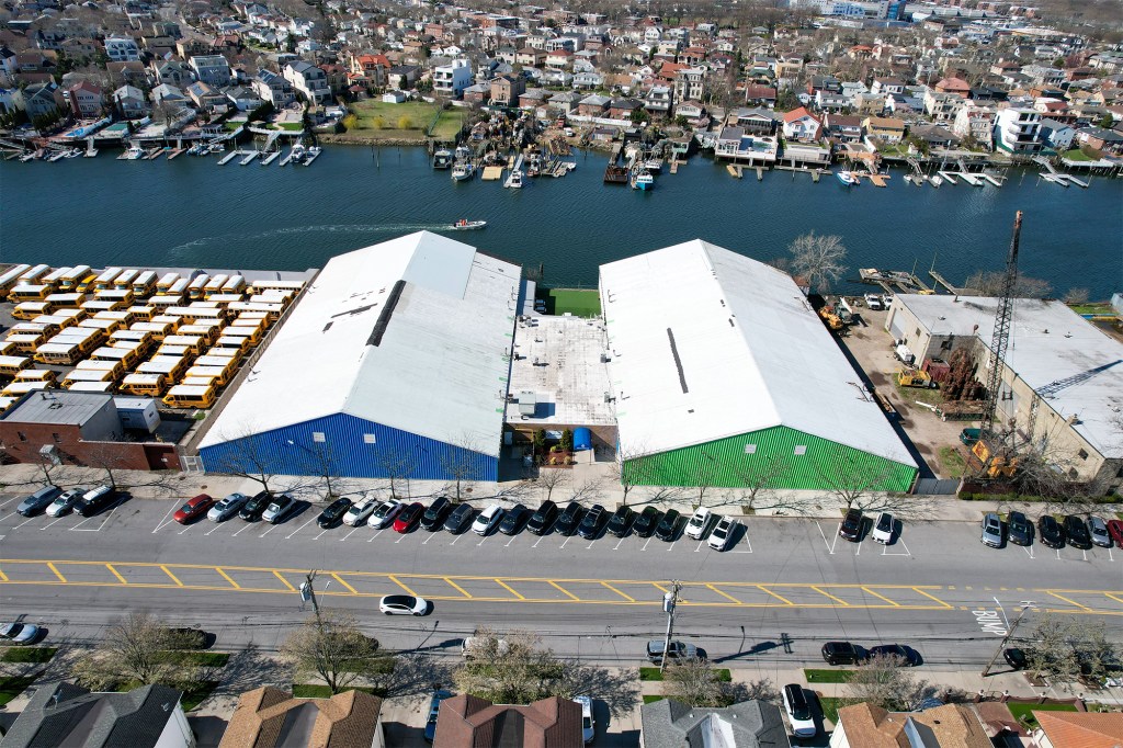 Aerial view of 2350 E. 69th St. in Brooklyn's Bergen Beach, showing two buildings, a parking lot, and school buses.