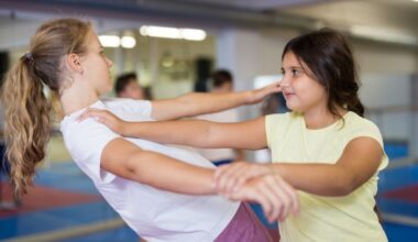 Two girls practice self-defense moves.