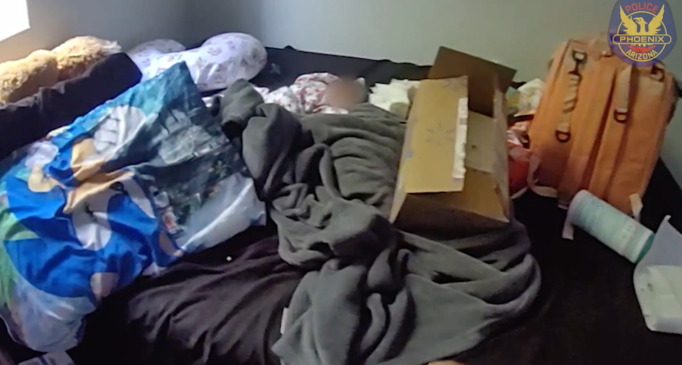 The infant was found lying on a bed after its mother died. Neighbors were praised for raising the alarm (Phoenix Police Department)