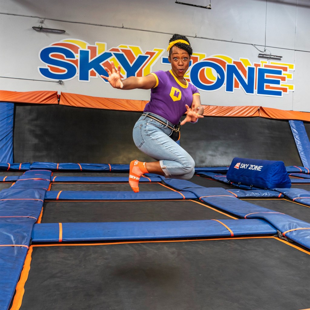 Woman jumping on a trampoline at Sky Zone.