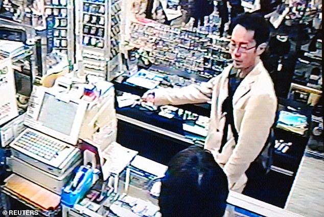 Frame grab from surveillance camera footage shows Akihabara stabbing perpetrator Tomohiro Kato purchasing knives