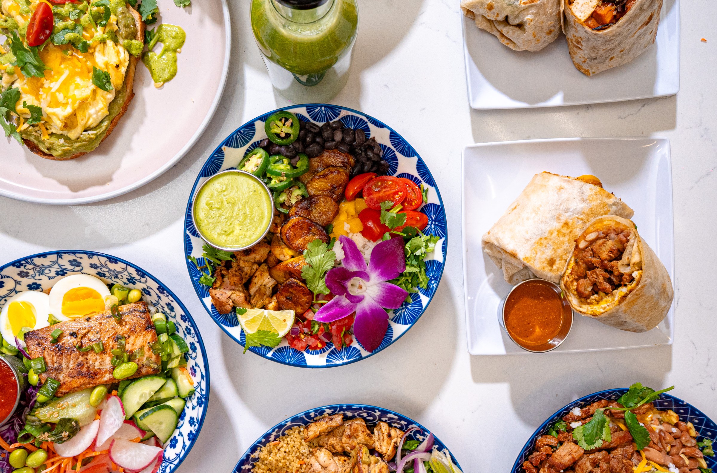 Overhead shot of a spread of dishes including burritos at A Lo Fresco