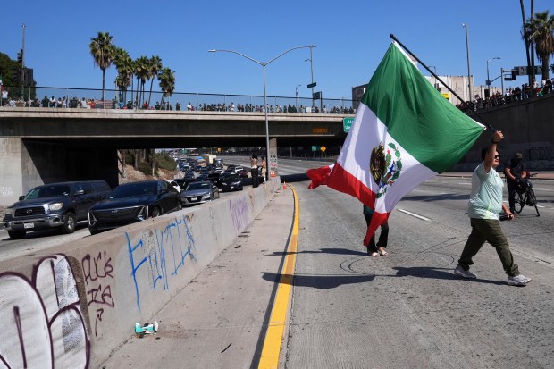 Protesters block the 101 Freeway near the metropolitan detention center...