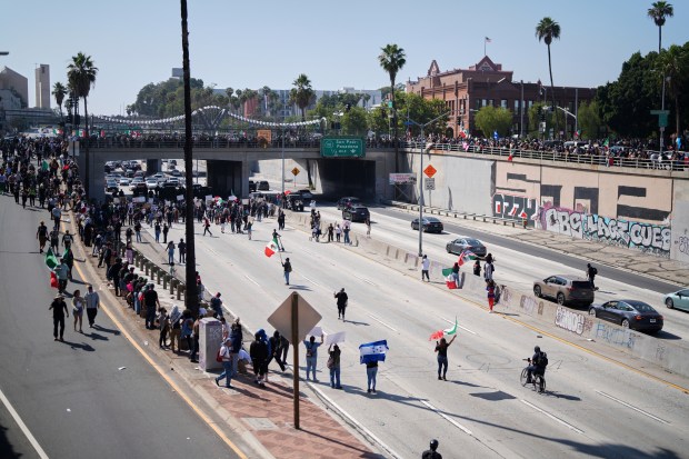 Protesters block the 101 Freeway near the metropolitan detention center...
