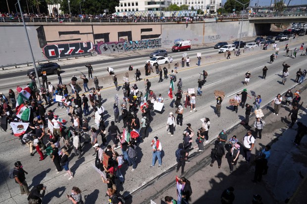 Protesters block the 101 Freeway near the metropolitan detention center...