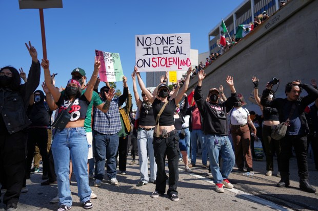 Protesters block the 101 Freeway near the metropolitan detention center...