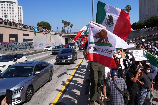 Protesters block the 101 Freeway near the metropolitan detention center...